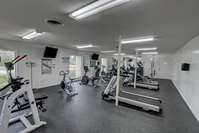 workout area featuring a textured ceiling