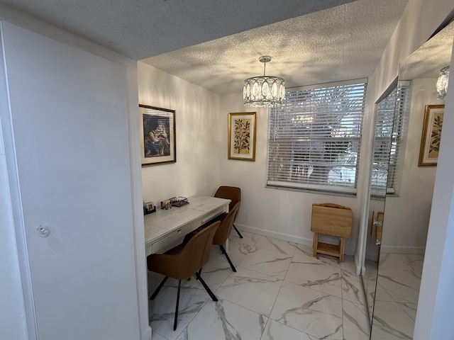 home office with a textured ceiling and an inviting chandelier