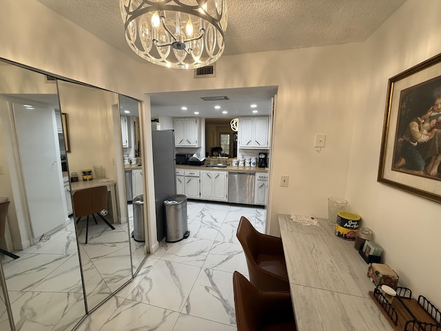 interior space with sink and a textured ceiling