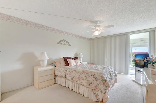 bedroom with ceiling fan, light colored carpet, a textured ceiling, and access to outside