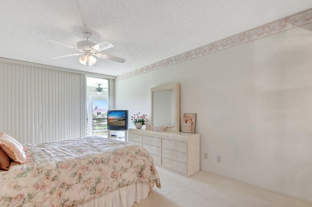 carpeted bedroom featuring a textured ceiling and ceiling fan