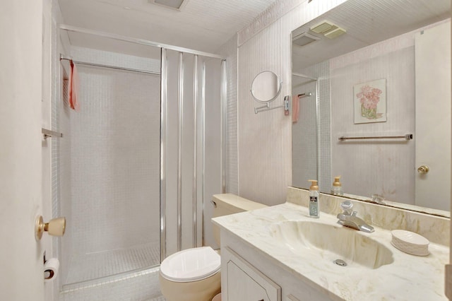 bathroom featuring an enclosed shower, vanity, and toilet