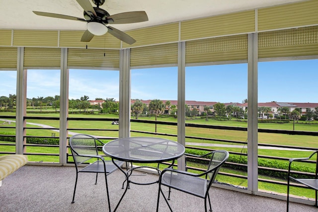 sunroom / solarium featuring ceiling fan