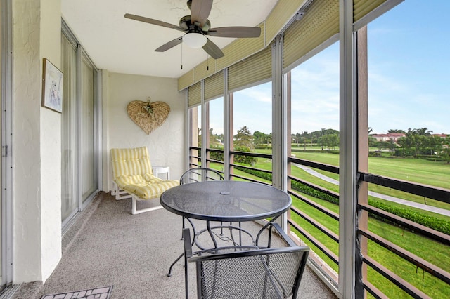 sunroom featuring ceiling fan