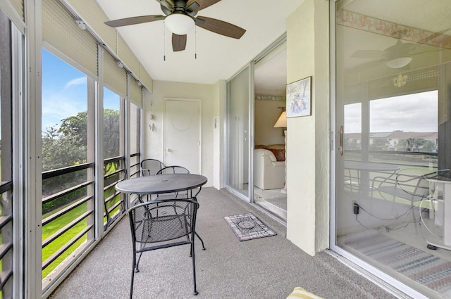 sunroom / solarium featuring ceiling fan