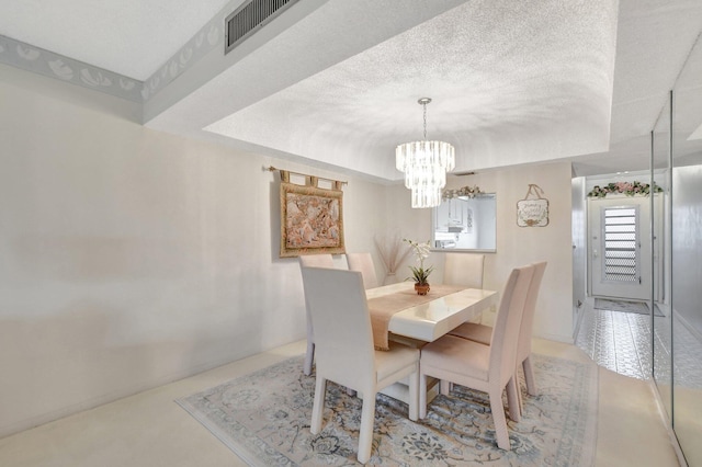 dining area with a notable chandelier and a textured ceiling