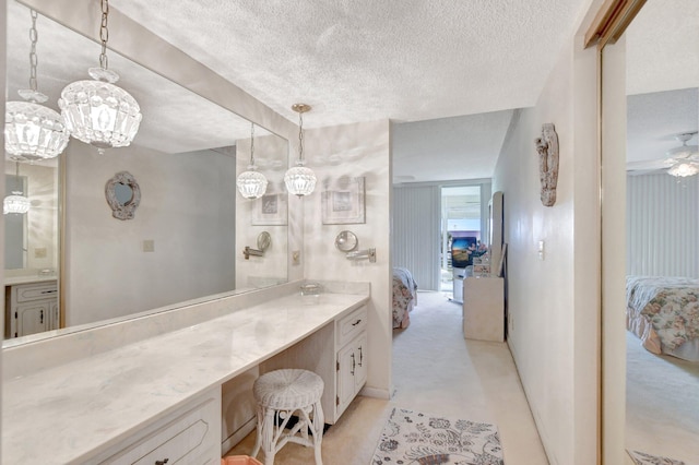 bathroom featuring concrete floors, ceiling fan, vanity, and a textured ceiling