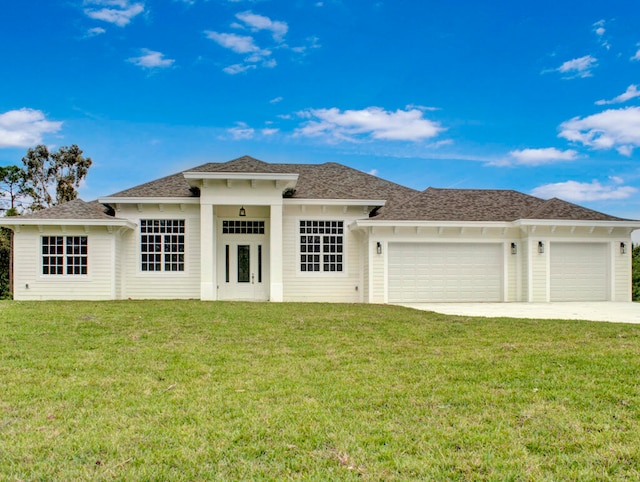 view of front of home featuring a garage and a front yard