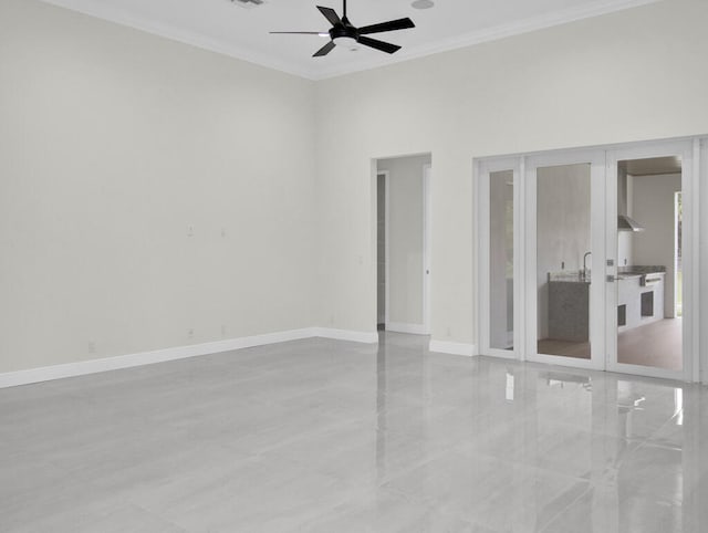 unfurnished room with ornamental molding, ceiling fan, and a high ceiling