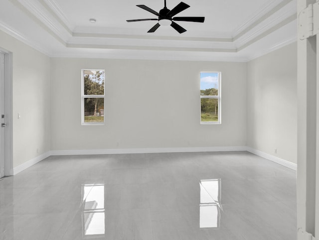 spare room featuring ceiling fan, crown molding, and a tray ceiling