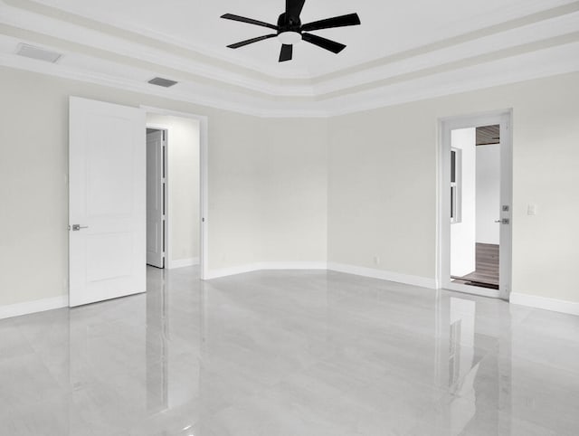 empty room with ceiling fan, crown molding, and a tray ceiling