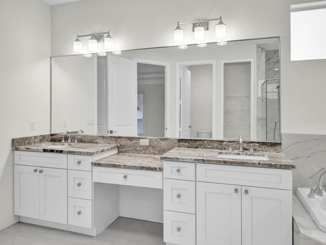 full bathroom featuring vanity, toilet, and separate shower and tub