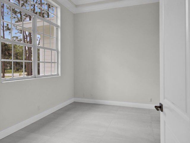 spare room with crown molding and plenty of natural light