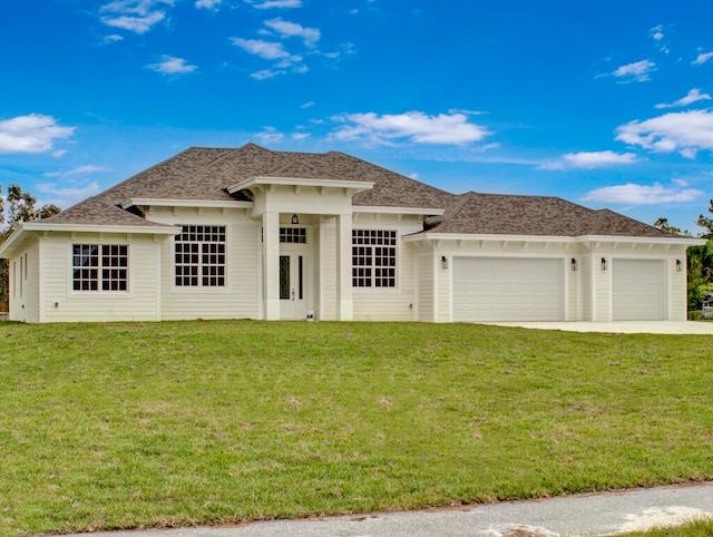 view of front of house with a garage and a front lawn