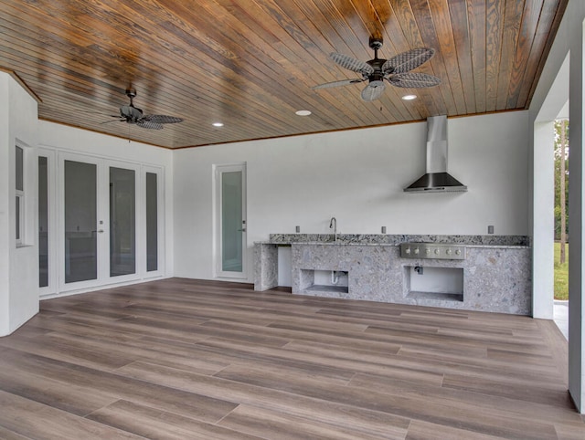 view of patio with an outdoor kitchen, ceiling fan, sink, and french doors