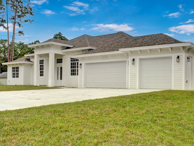 view of front of house featuring a front yard and a garage