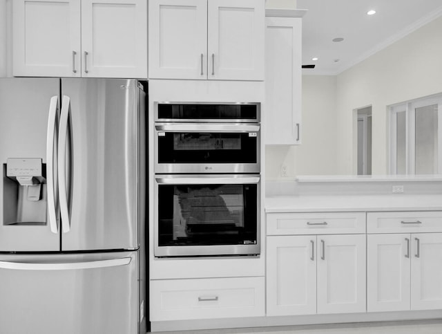 kitchen with white cabinets and appliances with stainless steel finishes