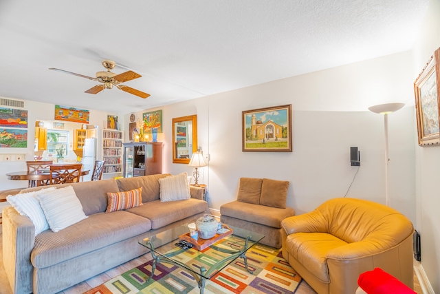 living room featuring light hardwood / wood-style flooring and ceiling fan