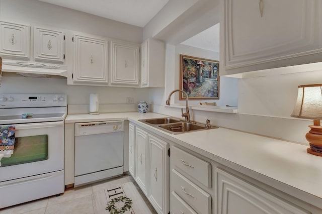 kitchen with sink, white cabinets, white appliances, and light tile patterned floors