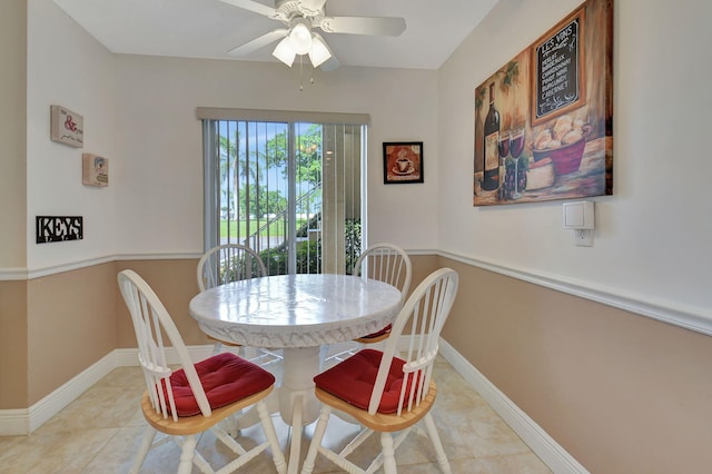 tiled dining room featuring ceiling fan