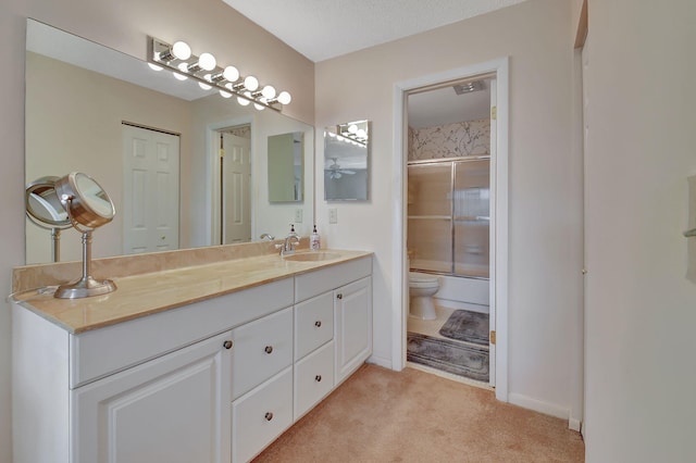 bathroom with toilet, a textured ceiling, and vanity