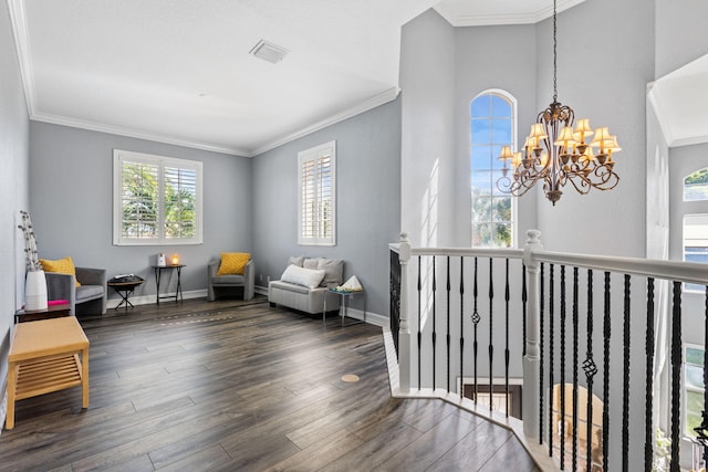 living area featuring a notable chandelier, crown molding, and dark hardwood / wood-style flooring