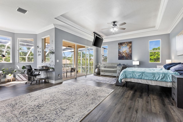 bedroom featuring dark hardwood / wood-style floors, access to exterior, and multiple windows