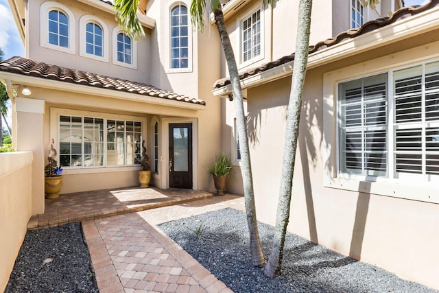 view of exterior entry featuring a patio area