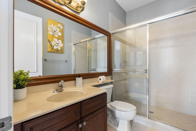 bathroom with an enclosed shower, tile patterned floors, vanity, and toilet