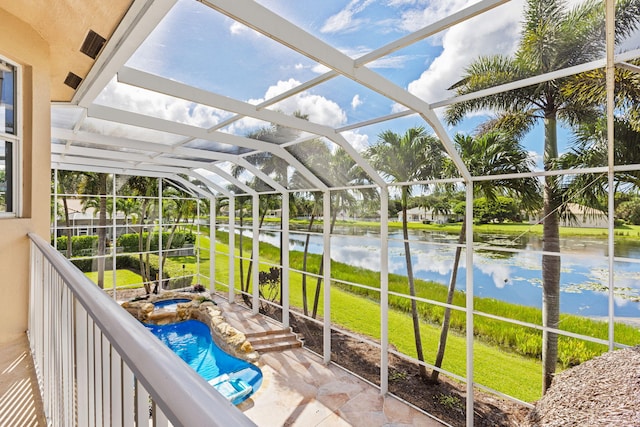 sunroom / solarium featuring a water view