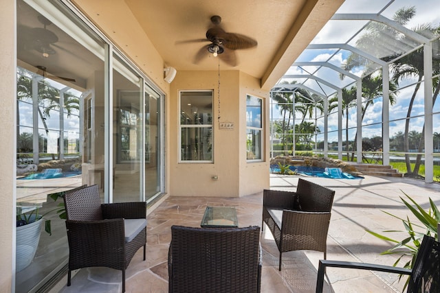 view of patio with ceiling fan and a lanai