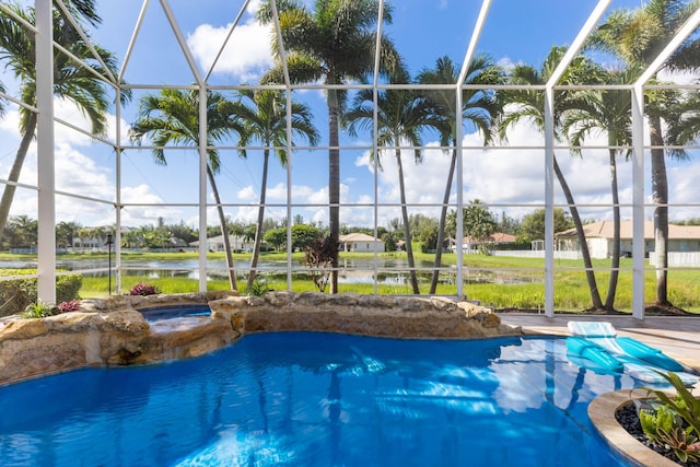 view of swimming pool featuring a water view, an in ground hot tub, and a lanai