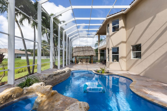 view of swimming pool featuring a lanai and a patio area