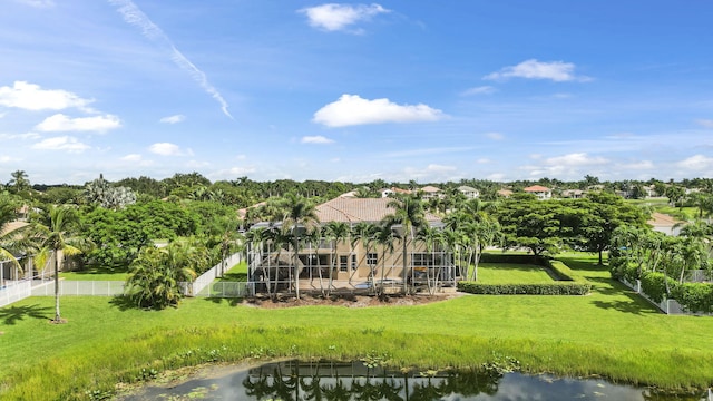 back of property featuring a water view and a lawn