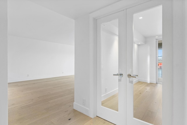 bathroom featuring hardwood / wood-style floors and french doors