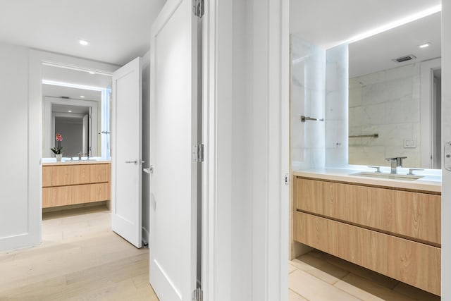 bathroom with hardwood / wood-style flooring and vanity