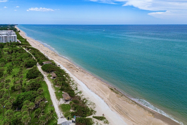 birds eye view of property featuring a view of the beach and a water view