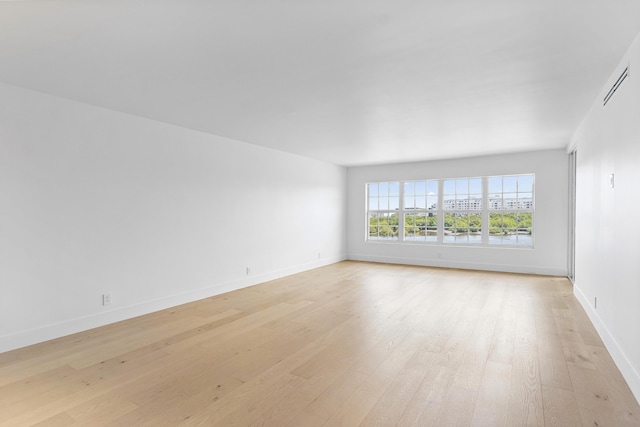 unfurnished room with light hardwood / wood-style floors