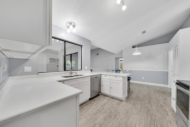 kitchen with kitchen peninsula, stainless steel appliances, vaulted ceiling, white cabinetry, and hanging light fixtures