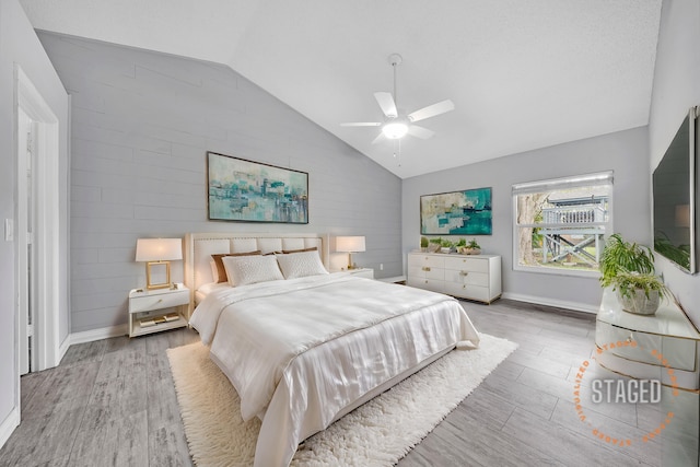 bedroom featuring hardwood / wood-style flooring, ceiling fan, and vaulted ceiling