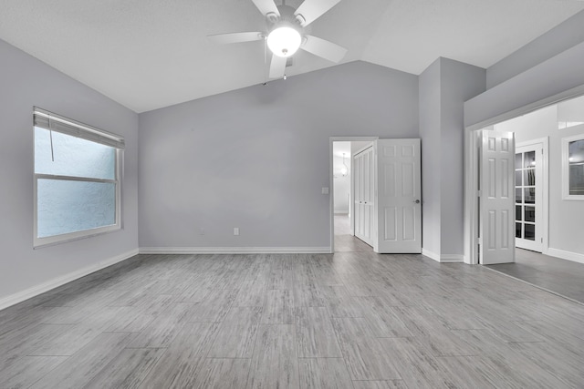 spare room featuring ceiling fan, light hardwood / wood-style flooring, and vaulted ceiling