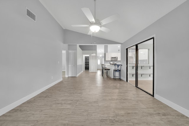 unfurnished living room featuring ceiling fan and lofted ceiling