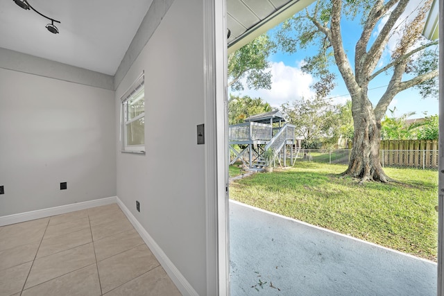 doorway to outside with light tile patterned floors and a wealth of natural light