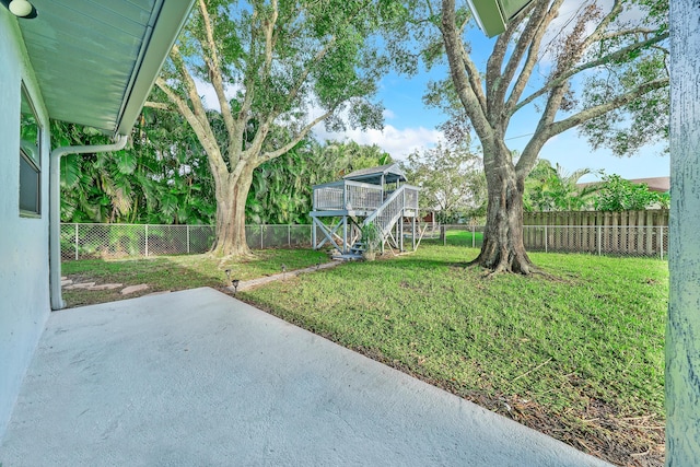 view of yard with a patio area and a wooden deck