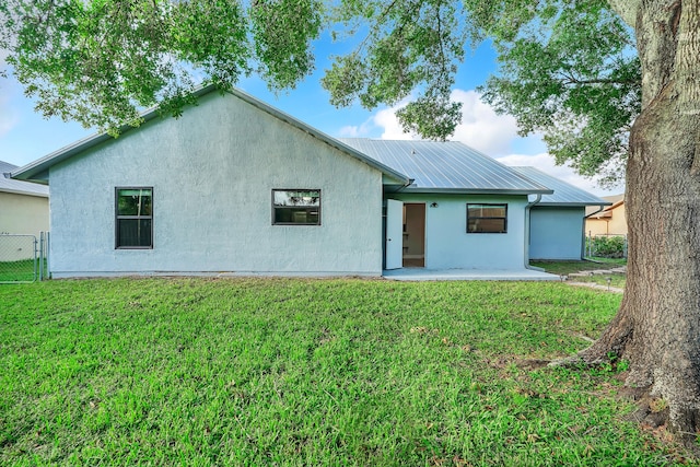 rear view of house with a lawn