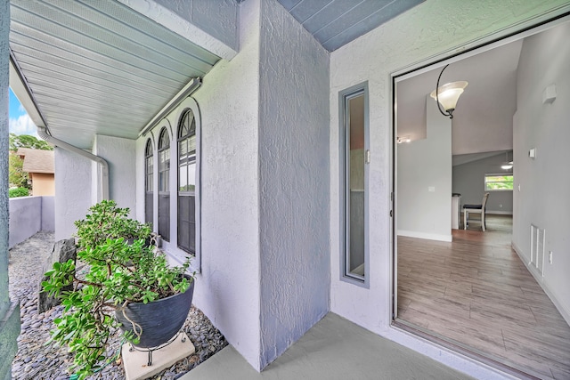 view of exterior entry featuring covered porch