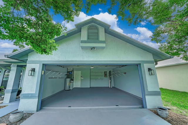 view of front of house with a garage and electric water heater