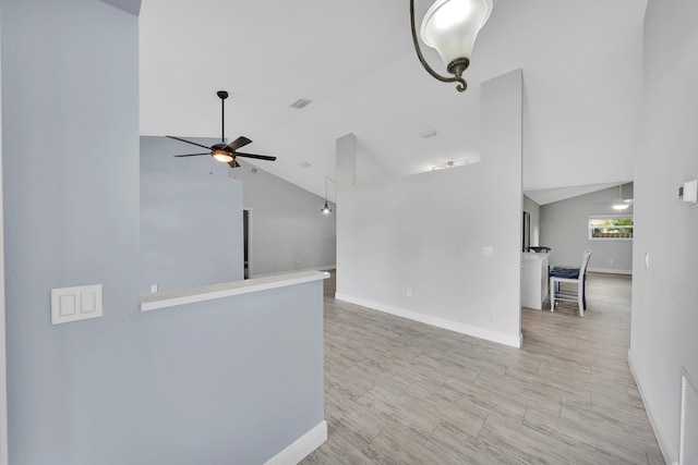 interior space featuring light wood-type flooring, high vaulted ceiling, and ceiling fan