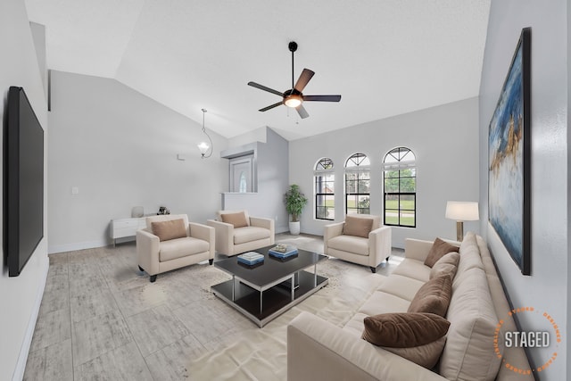 living room featuring ceiling fan and high vaulted ceiling