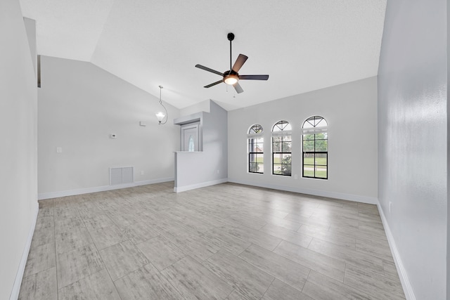 unfurnished living room with ceiling fan and lofted ceiling